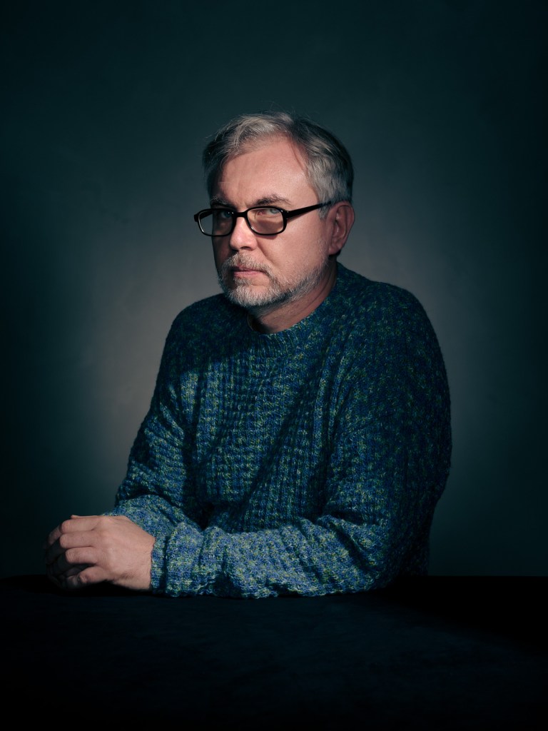 A fine art studio portrait of Andrii Kochmuradov, a Ukrainian advocate for the Portraits for Reparation project, photographed in The Hague, Netherlands by portrait photographer De Sheng Lim.