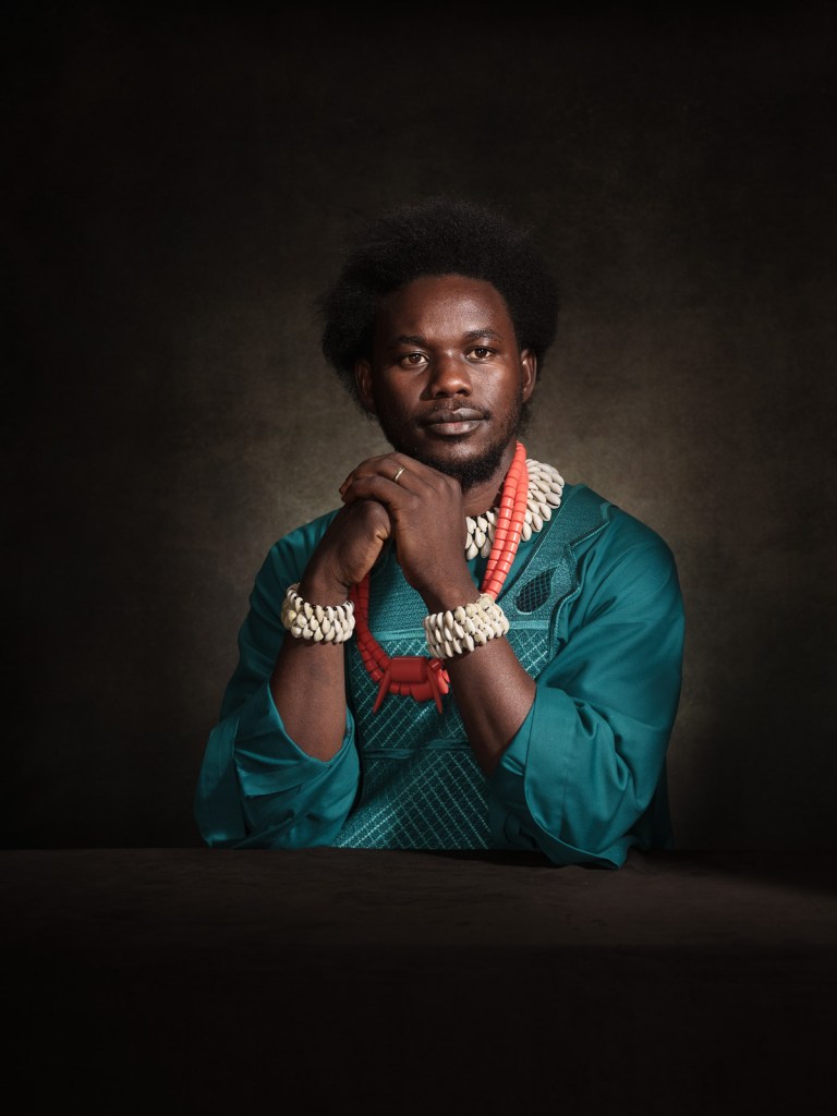 A fine art studio portrait of David Yambio, human rights defender and spokesperson for Refugees in Libya, for the "Survivors in Defence of ICC" project in The Hague, Netherlands, photographed by De Sheng Lim.