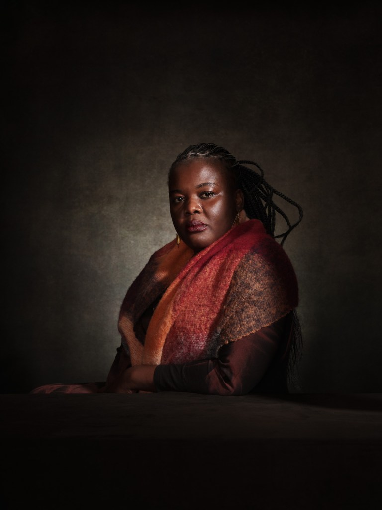 A fine art studio portrait of Elizabeth Atieno, Kenyan advocate for survivors of sexual and gender-based violence (Grace Agenda), for the "Survivors in Defence of ICC" project in The Hague, Netherlands, photographed by De Sheng Lim.