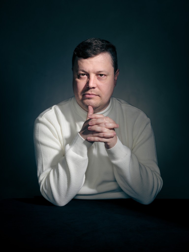 A fine art studio portrait of Kostiantyn Davydenko, a Ukrainian advocate for the Portraits for Reparation project, photographed in The Hague, Netherlands by portrait photographer De Sheng Lim.