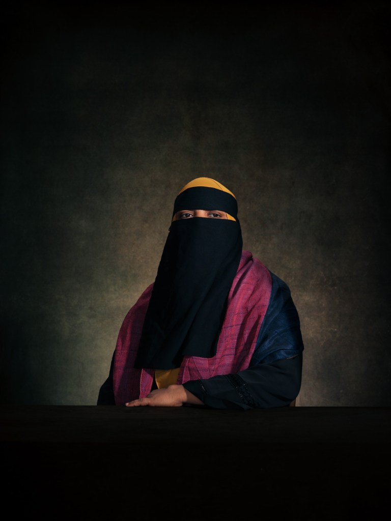 A fine art studio portrait of Salma, a survivor of sexual and gender-based crimes and member of the Shanti Mohila grassroots network, for the "Justice for Rohingya Survivors" project in The Hague, Netherlands, photographed by De Sheng Lim.