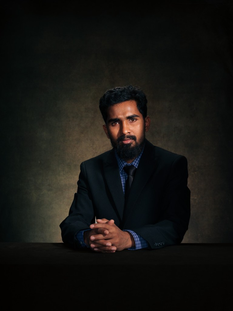 A fine art studio portrait of Sayedul Karim, human rights leader and head of the Rohingya Justice Initiative (RJI), for the "Justice for Rohingya Survivors" project in The Hague, Netherlands, photographed by De Sheng Lim.